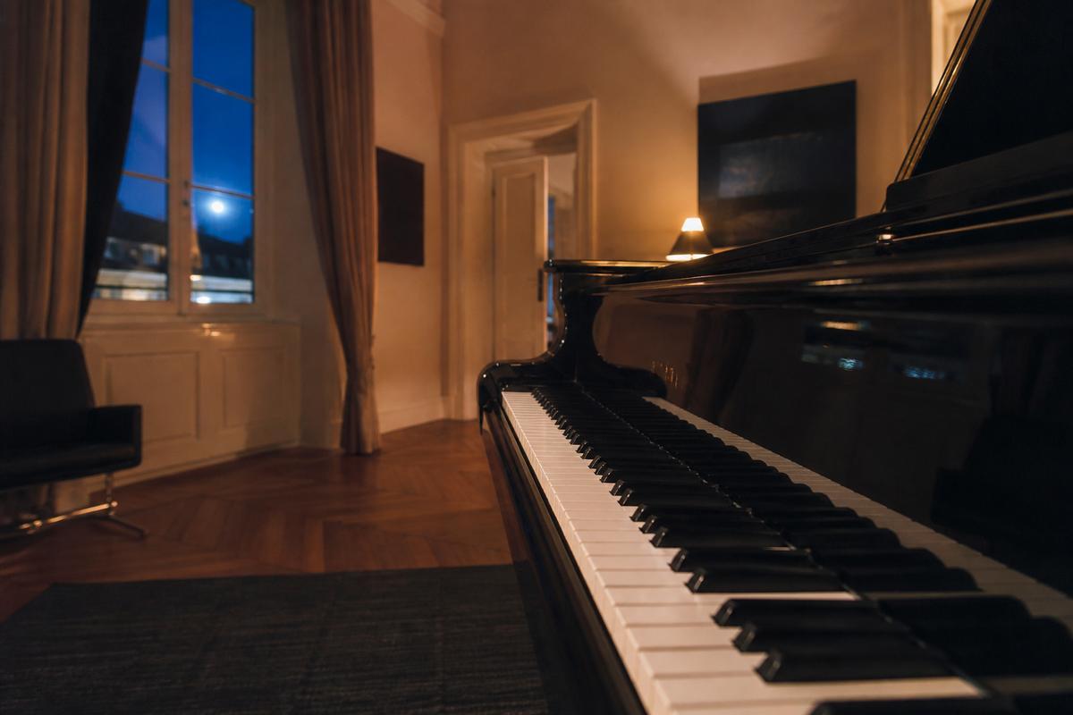 Grand piano keys in a quiet evening room